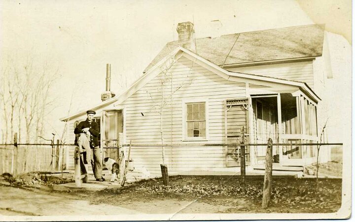 Ferd Gerkins stands in front of the family’s farmhouse in the early 1900s