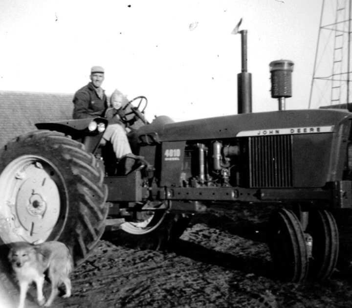 The Loberg duo, Glen and son Dan, pose with the family’s tractor. 