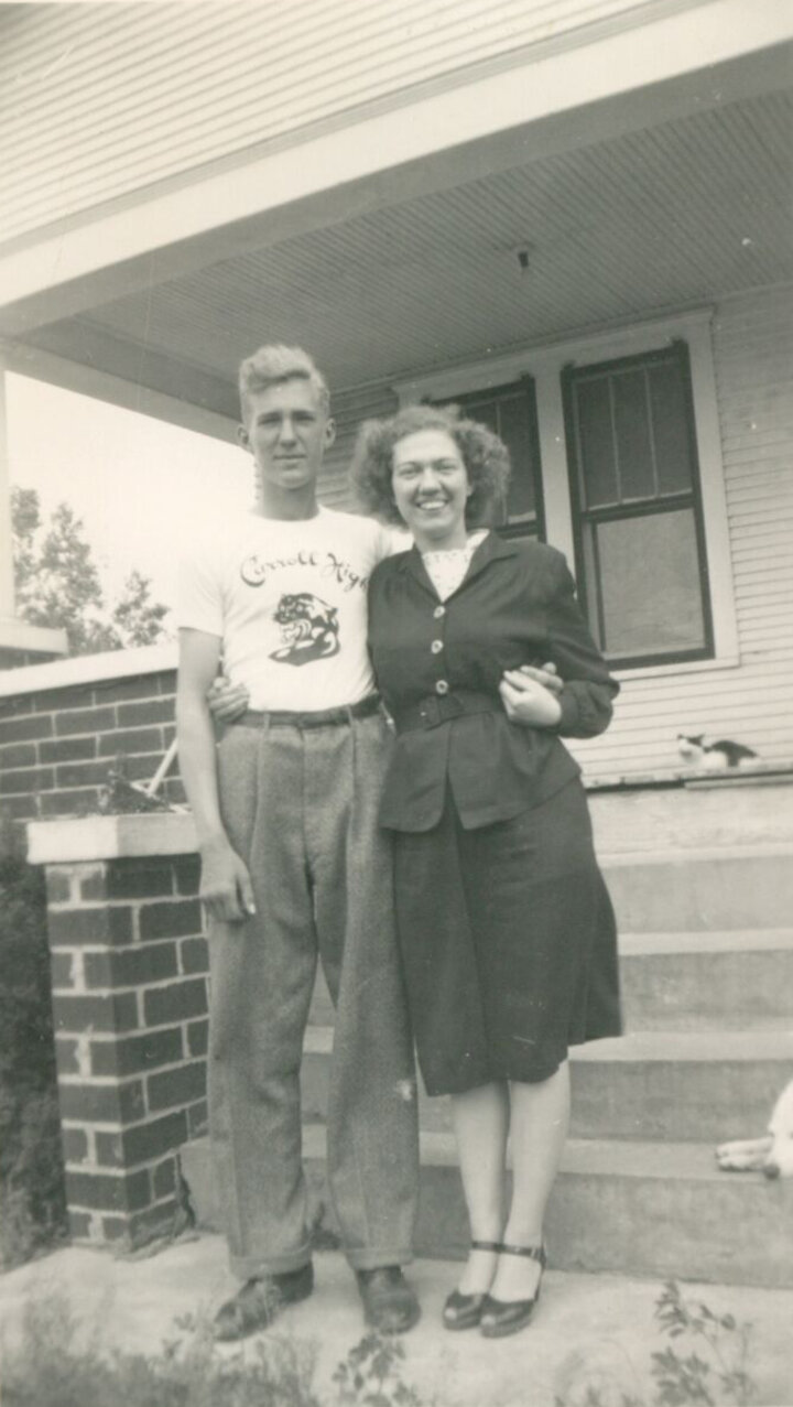 Glen and Kathleen Loberg in front of the original house. 